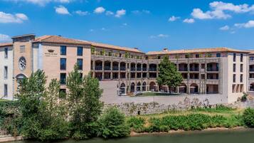 Un hôtel doté d’une cour intérieure, de sièges en plein air et offrant une vue sur la rivière.