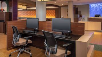 A modern office space with two computer workstations, each with a chair and a monitor.