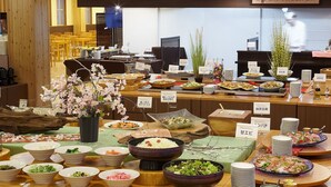 A buffet with various dishes and a decorative cherry blossom arrangement. - Yamadake Onsen Resort Shin Tamagawa Onsen (Senboku)