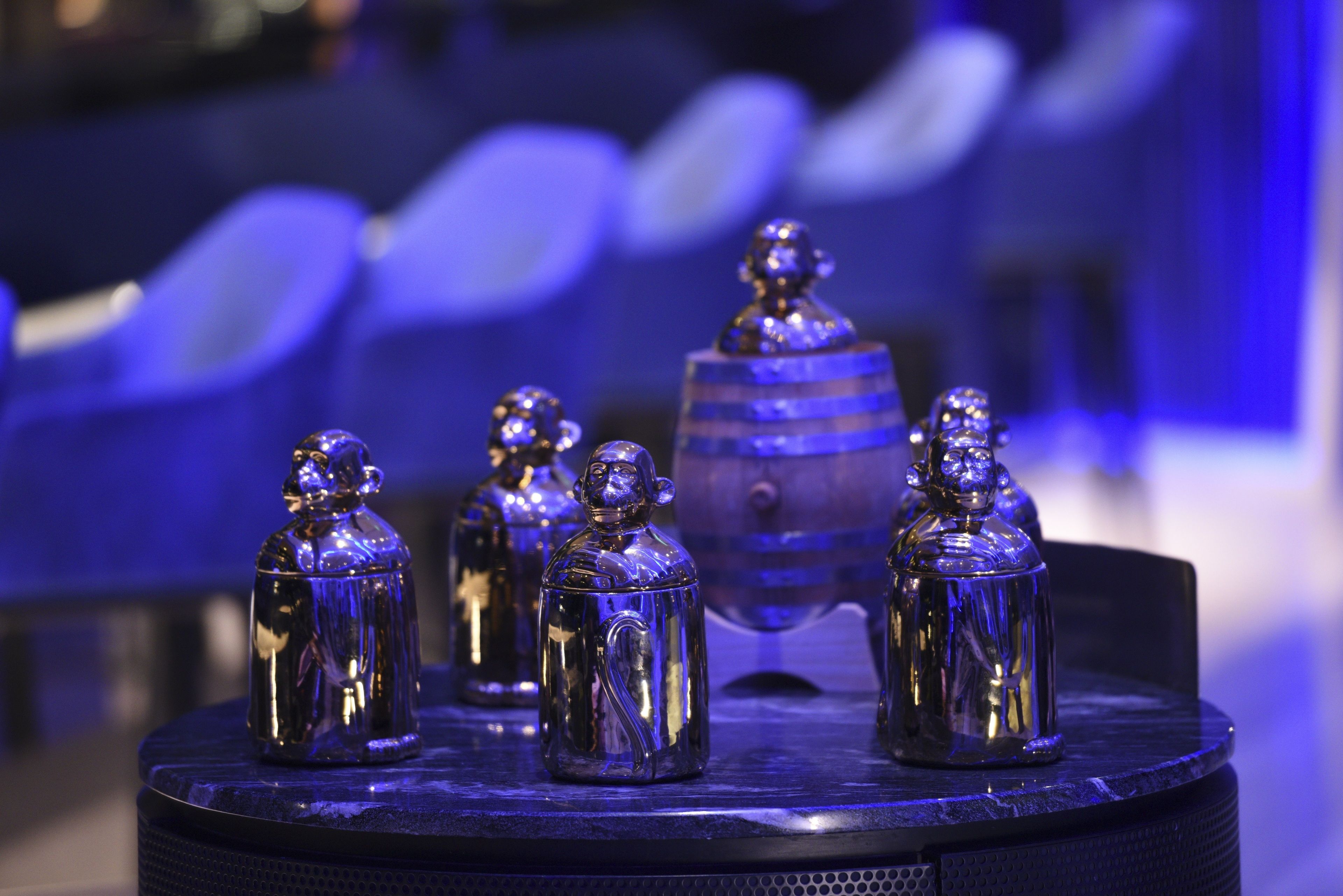A display of silver bell-shaped objects on a rotating stand.
