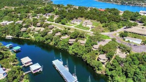 An aerial view of a lakeside community with houses, docks, and boats.