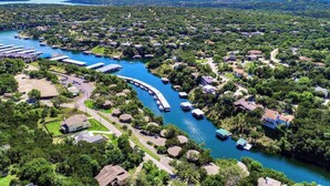 An aerial view of a residential area with a river, houses, and docks.