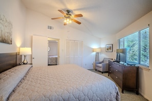 A bedroom with a bed, a desk, a chair, a ceiling fan, and a window with blinds. - Texas Star #13 - Treehouse Retreat with Pool Access (Lakeway)