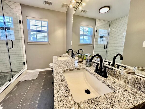 A modern bathroom with two sinks, a glass shower enclosure, and a large mirror. - Luxurious Franklin Experience! 5min To Downtown (Franklin)