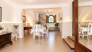 A spacious room with a dining area, a staircase, and a large mirror. - Can Pou - private pool - wifi - AACC (S'Aranjassa)