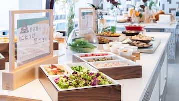 A buffet with various dishes and a signboard.