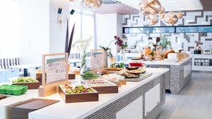 Een buffetopstelling met diverse gerechten en een bord met tekst.