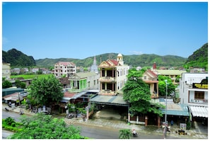 A town with buildings, a church, and a street. - Hoan Chau Homestay - Hostel (Phong Nha)