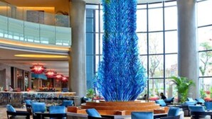 A spacious lobby with a large blue decorative feature, comfortable seating, and large windows allowing natural light. - Maya Gleetour Hotel Wuhan (Wuhan)