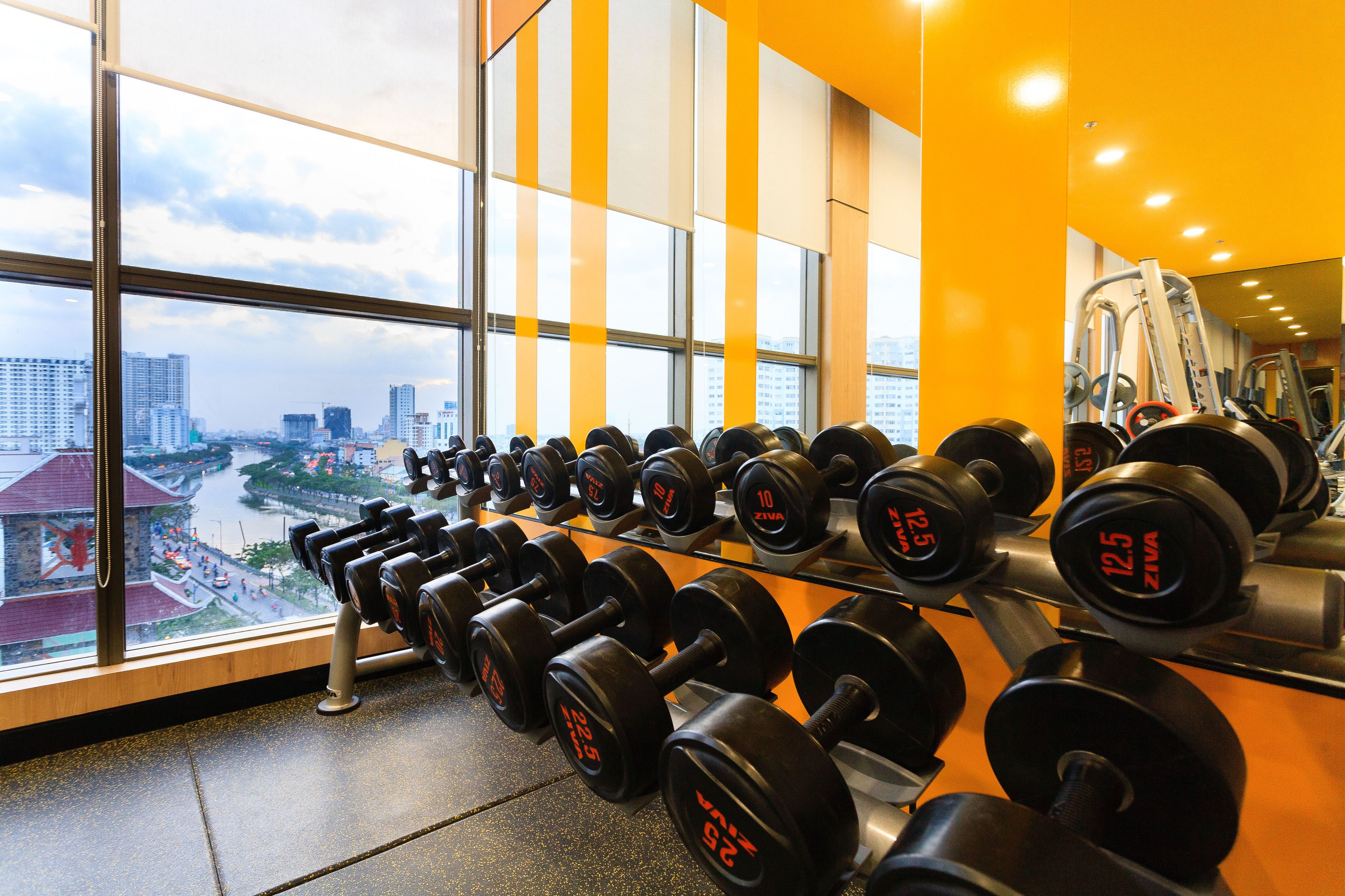 Un gimnasio con un amplio ventanal con vistas a un paisaje urbano.