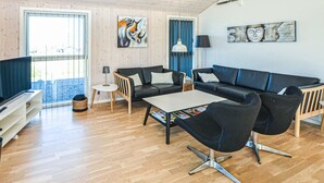 A modern living room with a sofa, chairs, a coffee table, and artwork on the walls. - 4 bedroom gorgeous home in Nordborg (Nordborg)