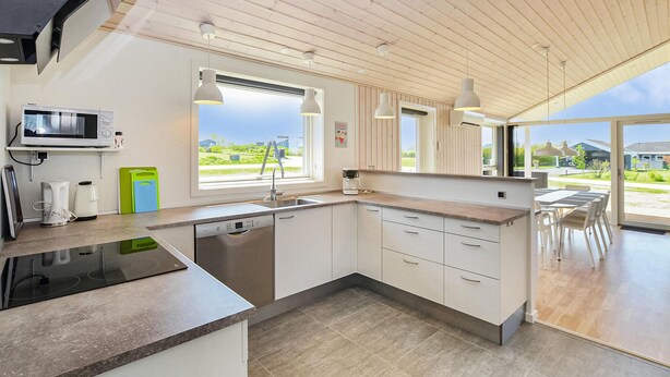 A modern kitchen with a built-in dishwasher, a microwave, and a coffee maker. - 4 bedroom gorgeous home in Nordborg (Nordborg)