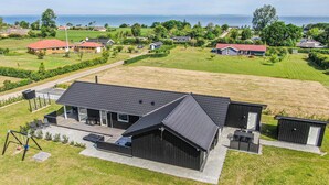 A modern house with a large deck, a garage, and a view of the sea. - 4 bedroom gorgeous home in Nordborg (Nordborg)