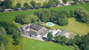 An aerial view of a residential property with a large house, a swimming pool, and a driveway. - Awesome apartment in Simpelveld with outdoor swimming pool (Simpelveld)