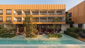A modern building with a pool, outdoor seating, and a well-maintained garden. - Craftsman Bangkok (Bangkok)