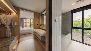 A modern bathroom with a large window, a built-in sink, and a wooden vanity. - Craftsman Bangkok (Bangkok)
