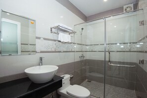 A modern bathroom with a glass-enclosed shower, a white sink, and a toilet. - An Bang Golden Beach Villa (Da Nang)