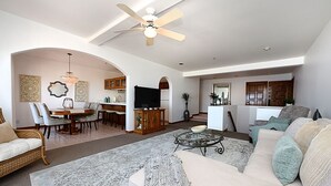 A spacious living room with a sofa, coffee table, and dining area. - H881: Beautiful Townhouse style villa + CART+ 2 Private Balconies + King bed (Avalon)