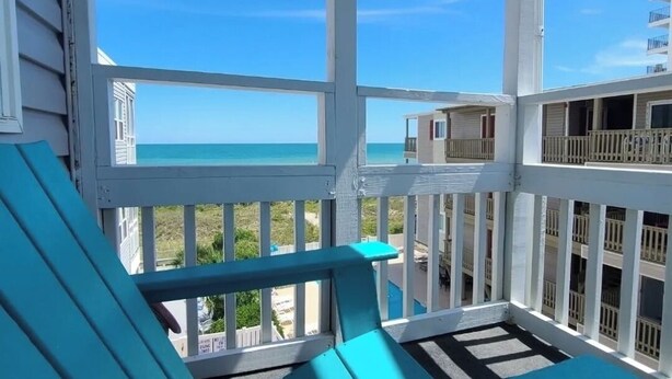 A turquoise deck with a view of the ocean and buildings in the background. - OceanThyme @ Windsong, Ocean Front Newly Remodeled and Decorated (North Myrtle Beach)