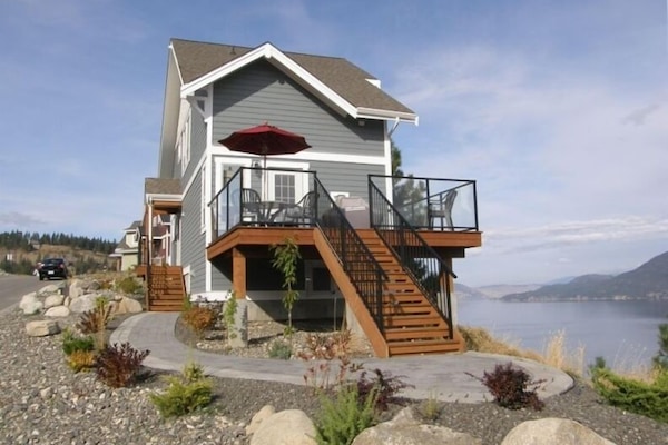 Cottage with deck and walkway overlooking Lake Okanagan. Fully landscaped.