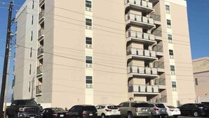 A multi-story hotel with a prominent sign on the top. - Oceanfront Studio, sleeps 4 -Private balcony, pool, hot tub, BBQ (South Padre Island)