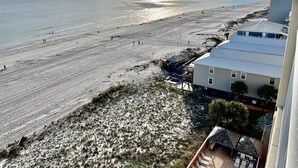 A beach view with a building featuring a flat roof and a balcony. - Beachfront Penthouse Located On The 9th Floor with Two Balconies & Low Host Fee (Gulf Shores)