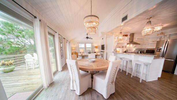 A spacious kitchen with a central island, white cabinetry, and stainless steel appliances. - 3BR/2BA 1st Tier, Timeless Beauty w/ Easy Beach Access & Clubhouse w/ Pool! (St. George Island)