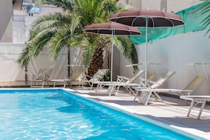 Seasonal outdoor pool, open 10:00 AM to 8:00 PM, pool umbrellas