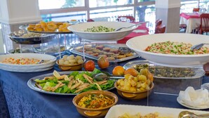 A buffet table with various dishes including salads, pasta, and desserts. - Hotel Plaza (Cattolica)