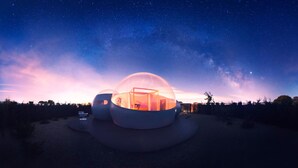 A spherical structure with an interior view, surrounded by a natural landscape under a starry sky. - Miluna (Hormigos)