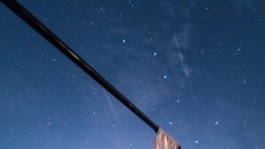 A bedroom with a bed, white curtains, and a view of the night sky. - Miluna (Hormigos)