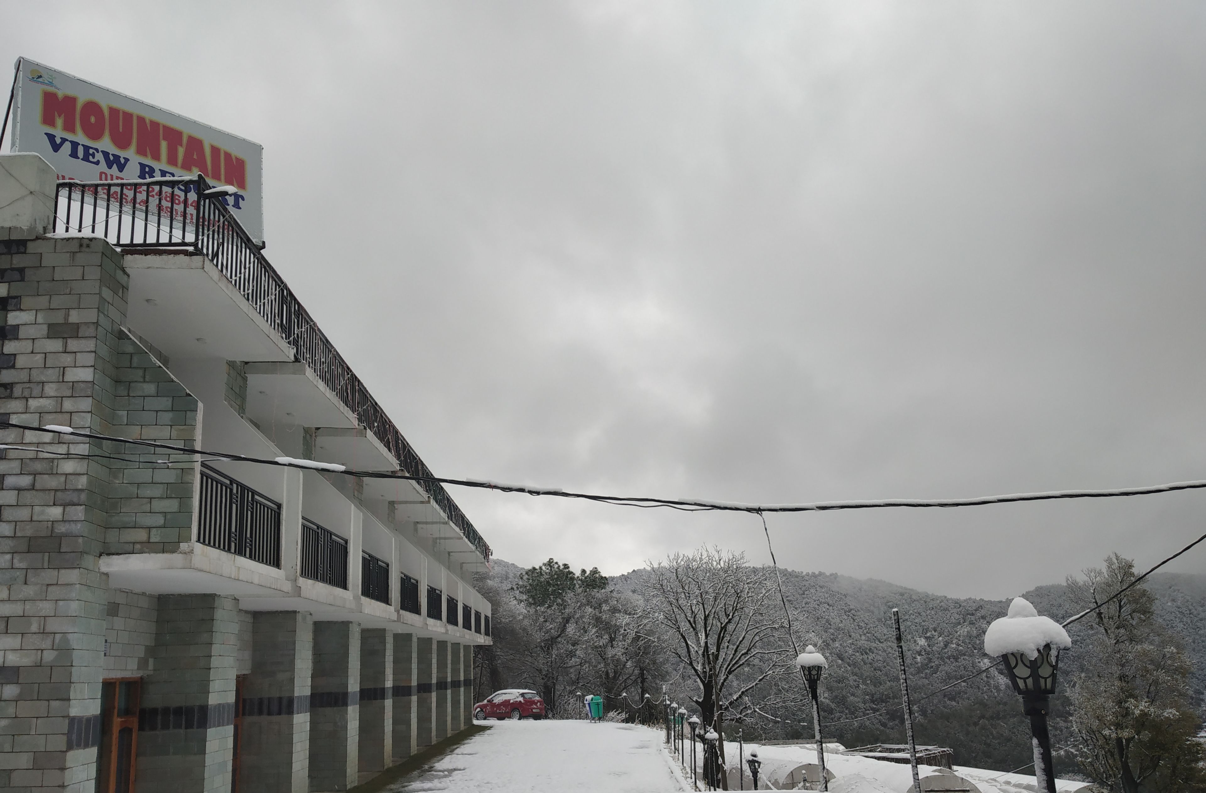 A building with a sign reading "MOUNTAIN VIEW" and a balcony with railings.