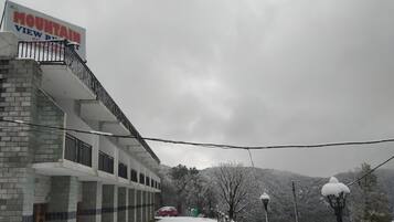 A building with a sign reading "MOUNTAIN VIEW" and a balcony with railings.