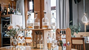 A bar area with various liquor bottles and a wooden counter. - Hotel Gasthof Koch (Daaden)