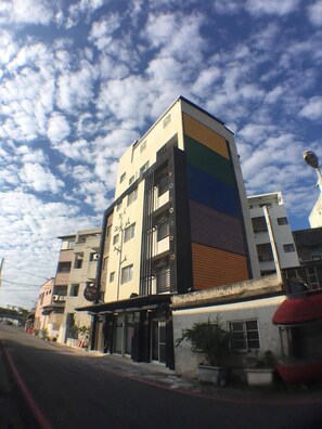 A multi-story building with a modern design, featuring a mix of balconies and windows. - Especially Chef's Home B&B (Hualien City)