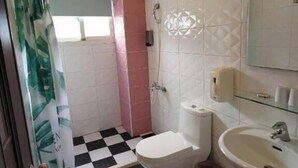 A bathroom with a toilet, sink, and shower area. - Especially Chef's Home B&B (Hualien City)