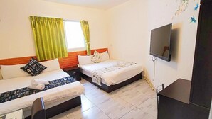 Une chambre d’hôtel avec deux lits, une télévision et un bureau.