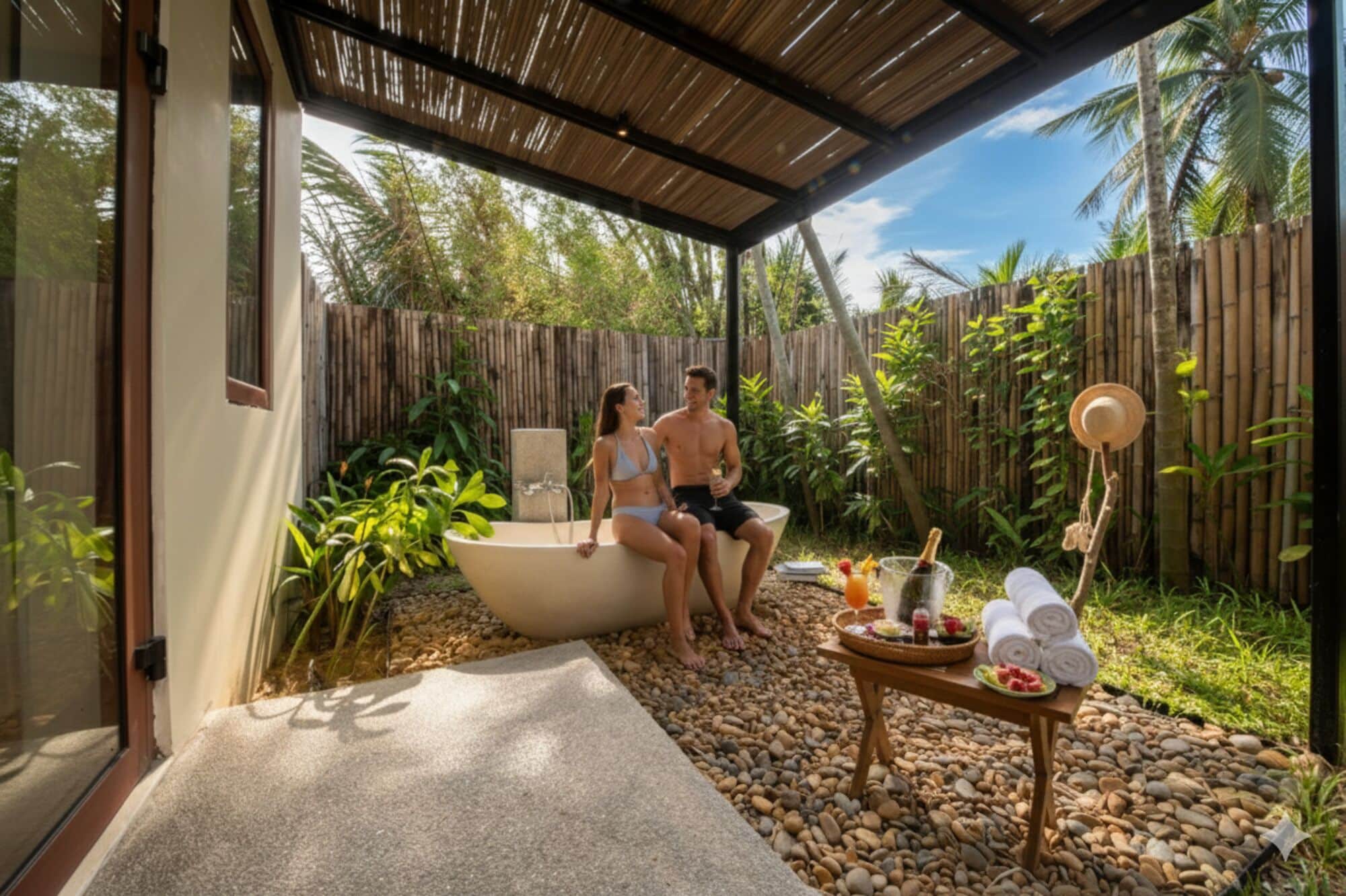 deluxe room, bathtub, pool view | bathroom | combined shower/bathtub, rainfall showerhead, free toiletries