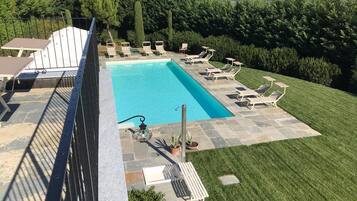 Seasonal outdoor pool, open 9:30 AM to 7 PM, pool umbrellas