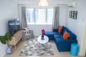 Grand Apartment, 2 Bedrooms, City View | Living area | 43-inch flat-screen TV with cable channels, TV, Netflix - Indigo BGC @ SOMA (Taguig)