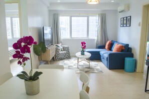 Grand Apartment, 2 Bedrooms, City View | Living area | 43-inch flat-screen TV with cable channels, TV, Netflix - Indigo BGC @ SOMA (Taguig)