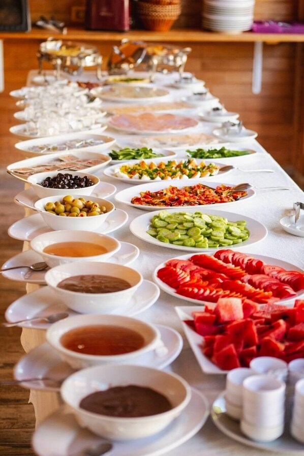 A buffet table with various food items and condiments. - 7 Green Adrasan (Kumluca)