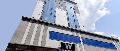 W Hotel features a sleek, contemporary design with a prominent sign and large windows.