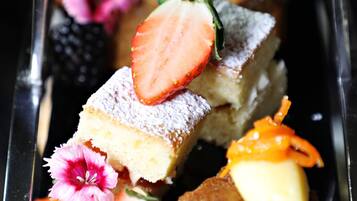 A dessert tray with various sweets and fruits.