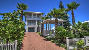 A two-story building with a covered walkway and a white fence. - Portofino - Private Beachfront House 3 Bedroom Home by RedAwning (South Padre Island)