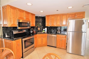 Condo, 2 Bedrooms | Private kitchen | Microwave, dishwasher, cookware/dishes/utensils, dining tables