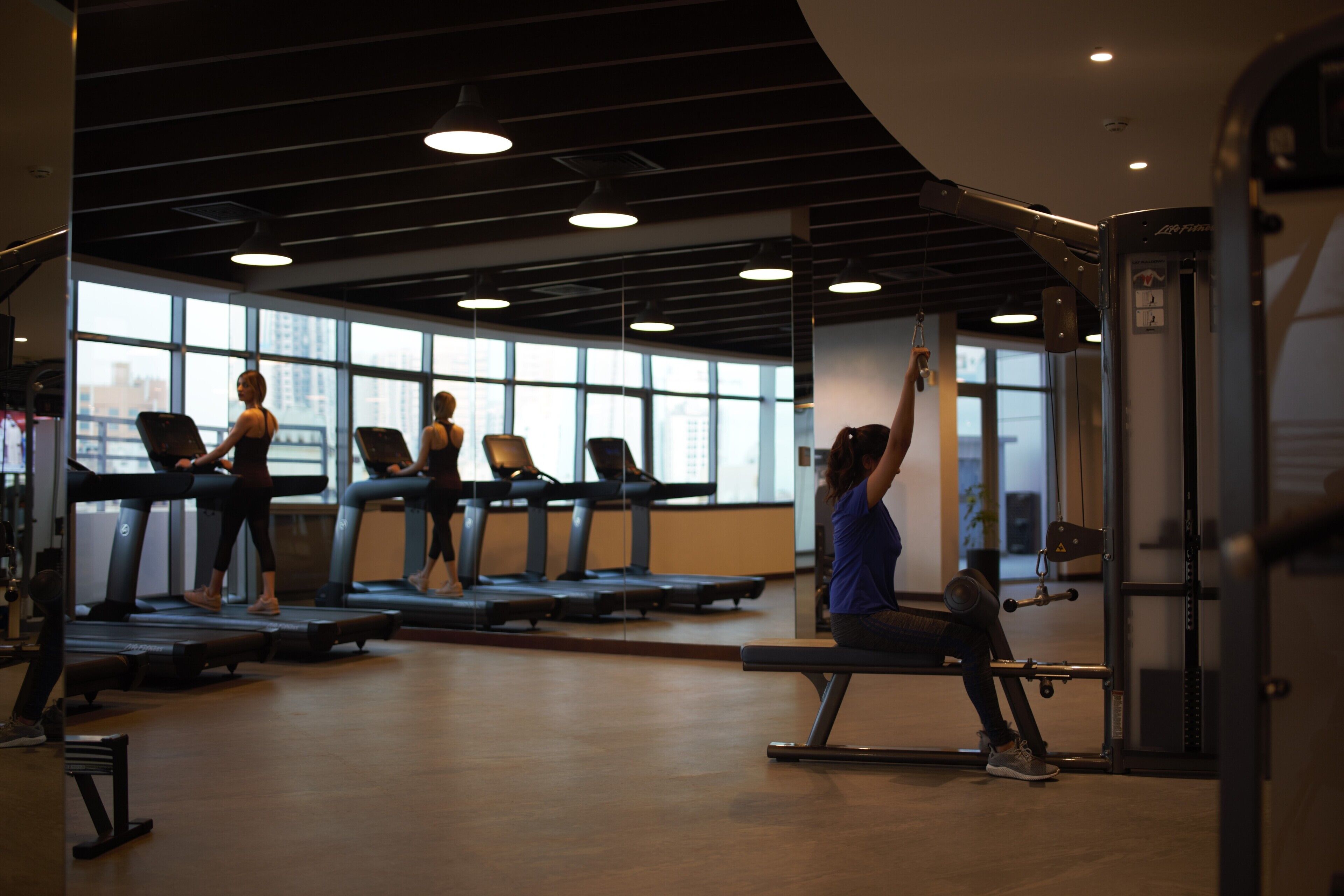 A gym with treadmills, a bench press, and weight machines.