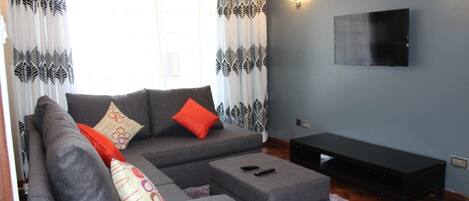 Apartment, 1 Bedroom | Living room | 32-inch flat-screen TV with satellite channels, TV