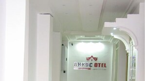A hotel entrance with a red carpet leading to a reception area. - Otel Akkoc (Isparta)