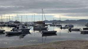 A marina with various boats docked, calm water, and distant mountains. - Destinos de Sol Los Alcázares (Los Alcazares)